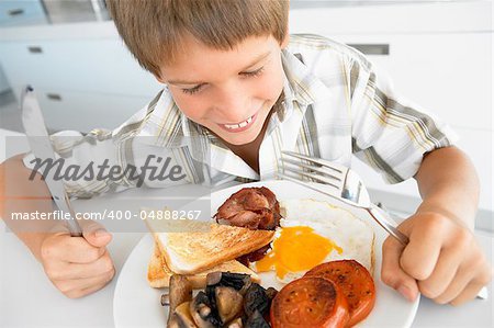 Young Boy Eating Unhealthy Fried Breakfast