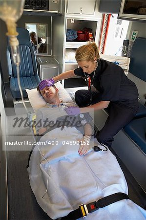 Paramedic with patient in ambulance