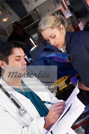 Paramedic advising doctor about arriving patient