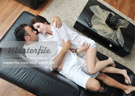 Portrait of a relaxed young guy using laptop at home indoor