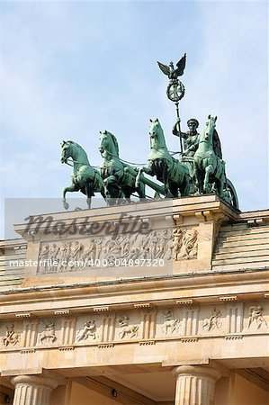 Detail of Brandenburg Gate and the Quadriga bronze statue. In german it is called Brandenburger Tor and it's one of the few monuments that survived in the defeated capitol town of Berlin after second world war. King Frederick William II of Prussia commissioned the Gate and Carl Gotthard Langhans built it from 1788 to 1791.