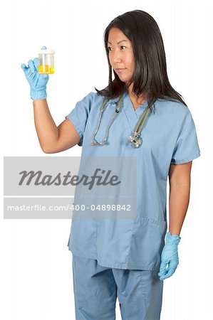 A beautiful young Asian woman doctor in scrubs holding a urine sample