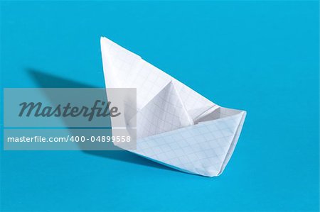 Paper ship, photo on the blue background