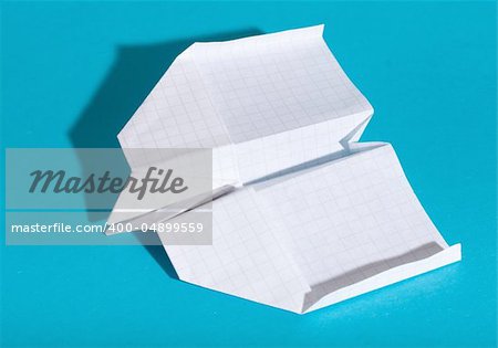 Paper airplane, photo on the blue background