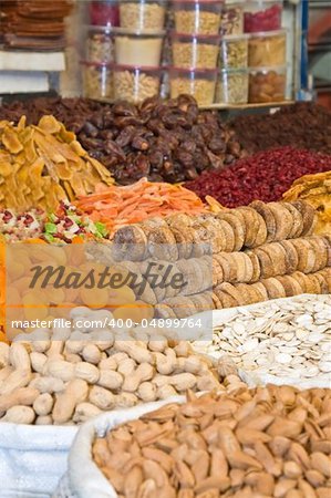 Colorful healthy dried fruits and nuts in the market, focus on figs