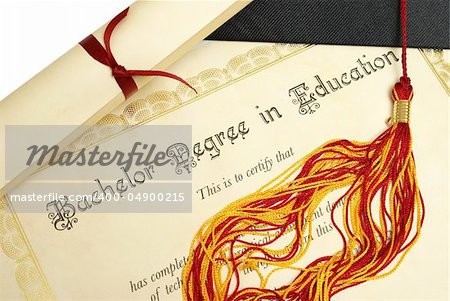 A diploma and grad hat represent a high achieving student in the field of education.