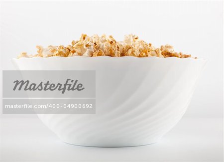 Big bowl of salty popcorn on light grey background