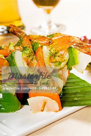 fresh and colorful grilled shrimps and vegetables skewers on a palm leaf ,thai style