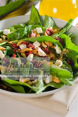 plate of fresh colorful spinach salad close up