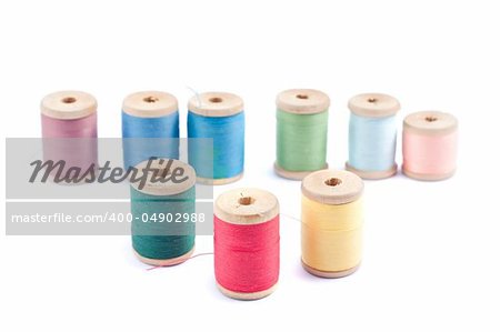 Spools of different colors thread isolated on white background