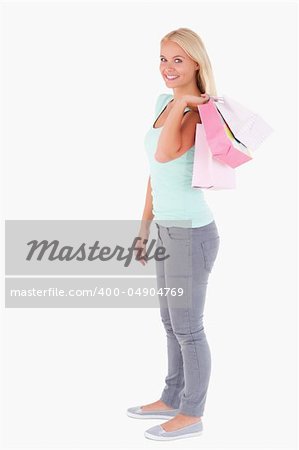 Joyful woman with some shopping bags in a studio