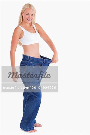 Charming woman wearing jeans that are too big