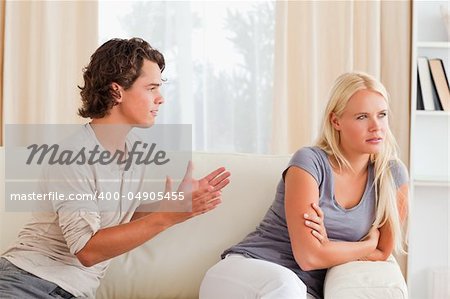 Young couple arguing in their living room