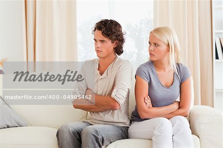 Young couple after an argument with the arms crossed