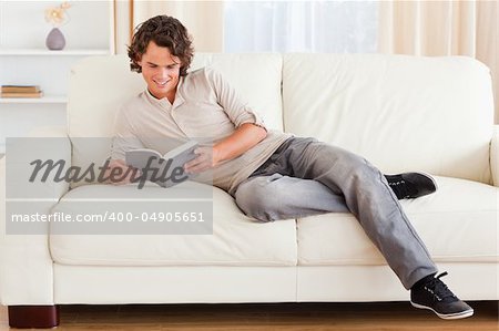 Man reading a book in his living room