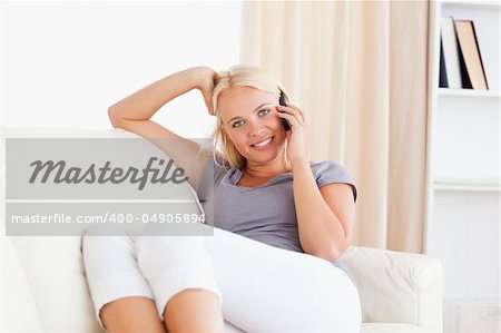 Woman making a phone call in her living room