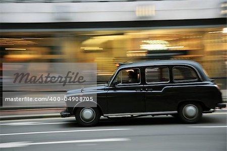 Taxi in the street of London. Cabs, Taxis, are the most iconic symbol of London as well as London's Red Double Decker Bus.