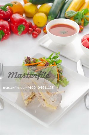 tuna fish and cheese sandwich with fresh mixed salad ,watermelon and gazpacho soup on side,with fresh vegetables on background ,MORE DELICIOUS FOOD ON PORTFOLIO