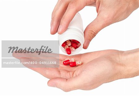 pills in a human hand isolated on white