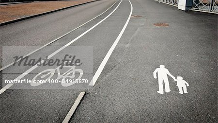 Painted signs on asphalt for pedestrian and bicycle dedicated lanes