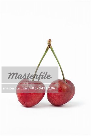 Two sweet cherries on white background