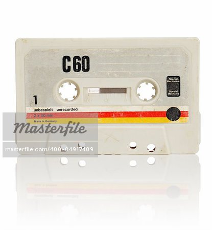 Vintage compact cassette audio tape on white with natural reflection.