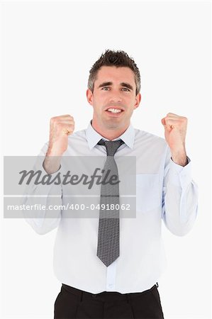 Portrait of a cheerful businessman with the fists up against a white background