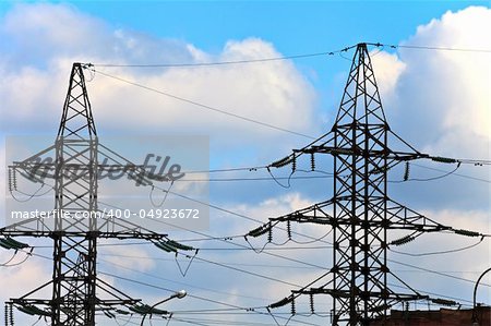 Two high voltage electricity towers on the sky background