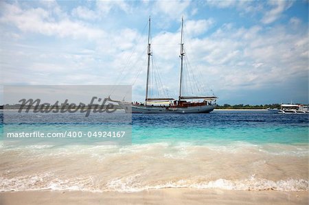 Boat passing through a stunning blue beach