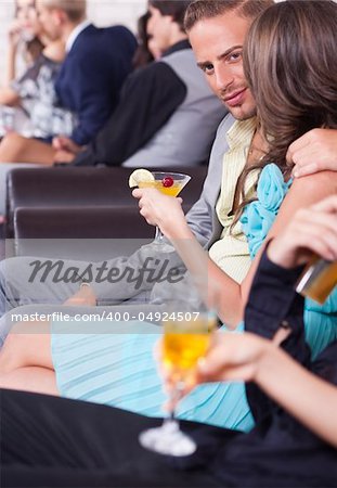 Three young couples with champagne glasses at celebration, party or romantic date in night club...