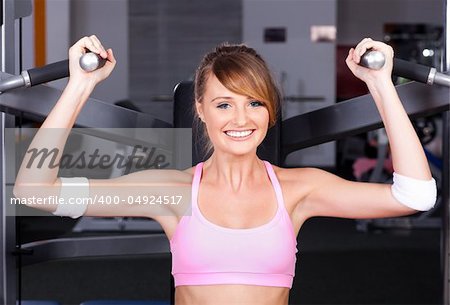 Beautiful woman at the gym, exercising...