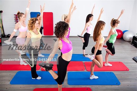 Group of gym people in a stretching class.