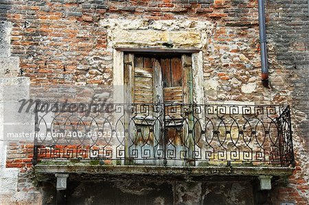 balcony of old brick building in Verona, Italy