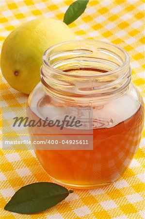 jar of fresh honey with the lemon