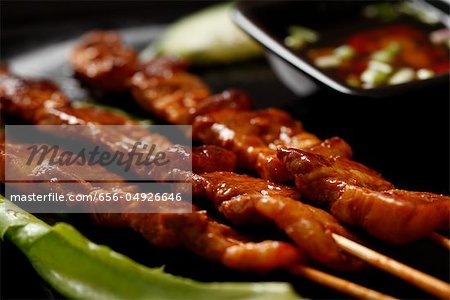 Beef satay with dipping sauce.