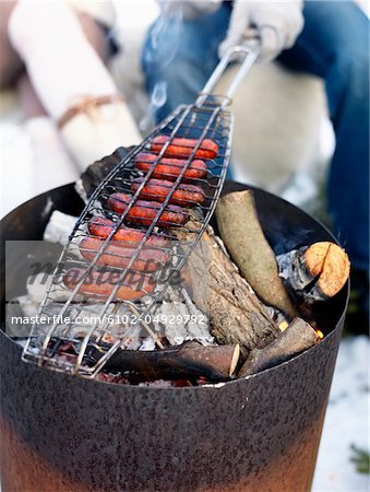 Barbecuing sausages, close-up