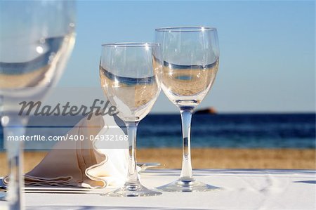 Lunch at the beach. Focus on the glass and napkin.