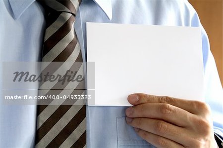 Man in tie holding a blank piece of paper.