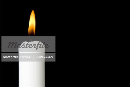 Horizontal close up of a candle isolated on black background