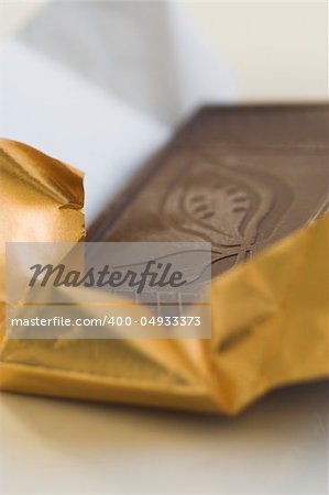 close-up of dark chocolate being unwrapped