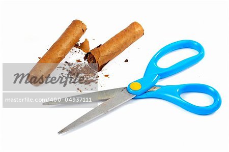 A scissors and broken cuban cigar on a white background