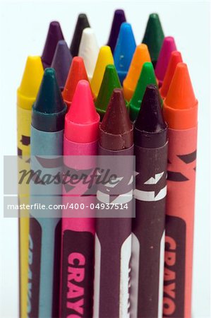 Multi coloured crayons against a plain background