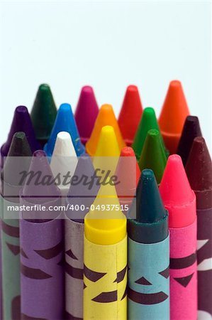 Multi coloured crayons against a plain background
