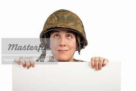 Curious soldier girl holding advertising space looking up