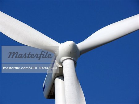 close-up portrait of wind turbine in blue sky