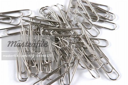 Silver paper clips isolated on white - office supplies