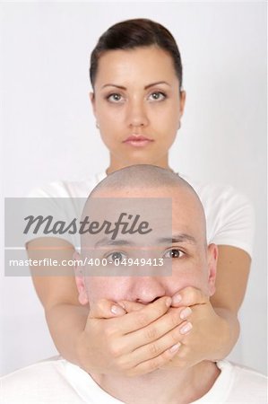 a woman covering man`s mouth with her hand