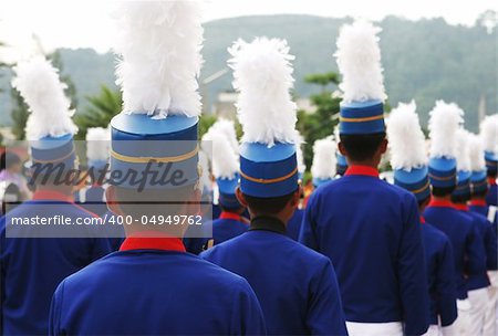 Group of marching boys in blue and white uniforms