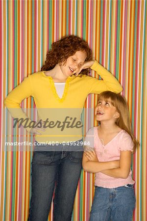 Caucasian female child leaning on smaller female child.