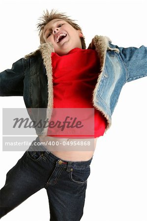 Ecstatic energetic boy leaping into the air, arms stretched out and head tilted back with expression of pure joy.  Parts of the jacket and t-shirt show motion.